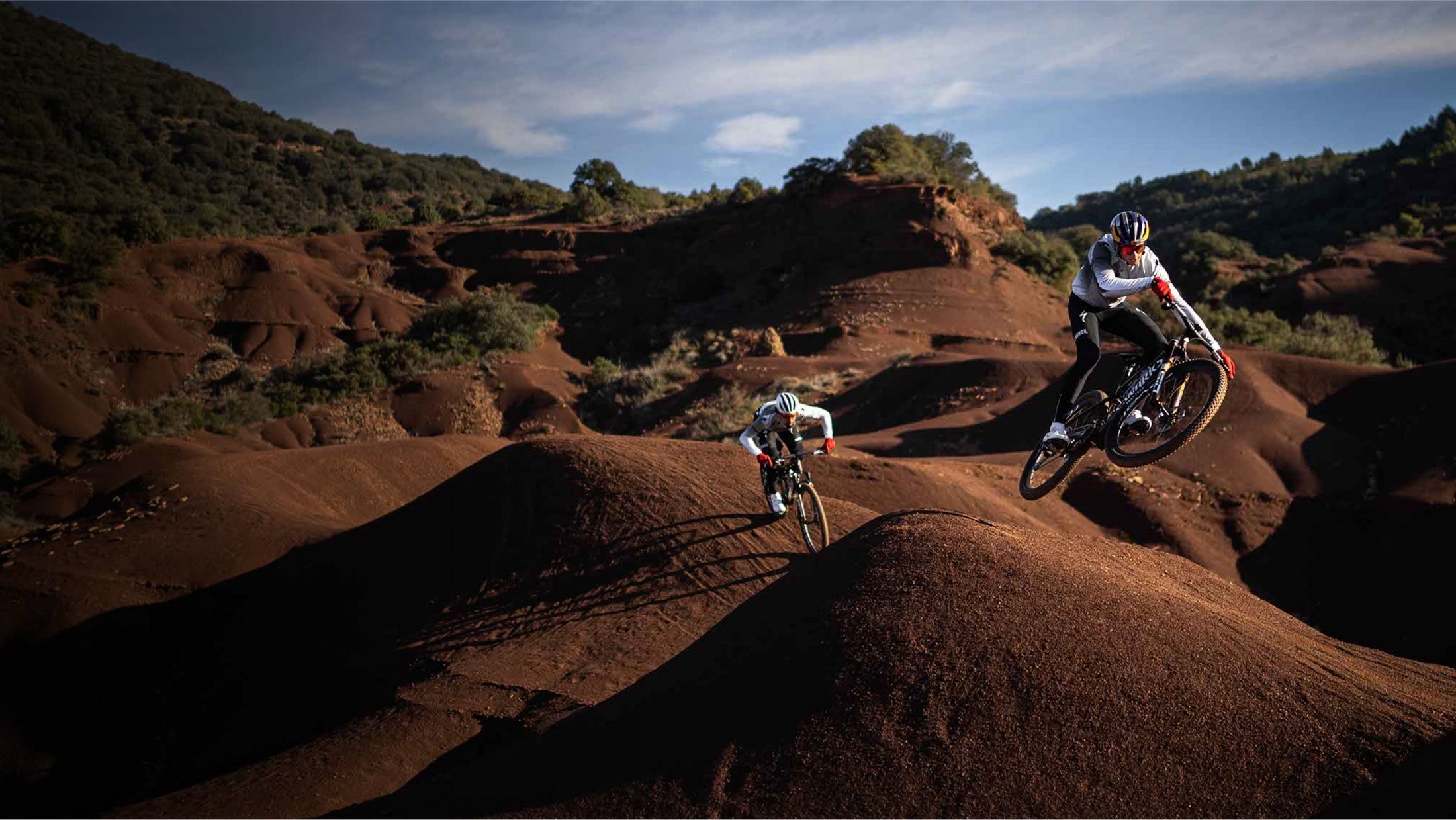 Riders racing the 2026 Specialized Epic 8 on a mountain trail